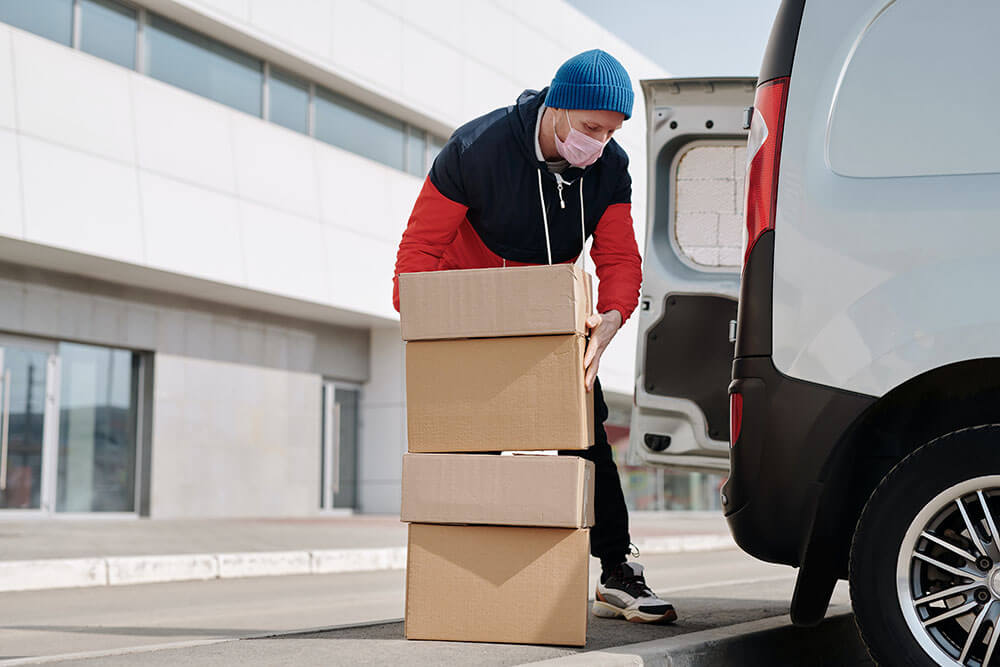 person loads boxes into van